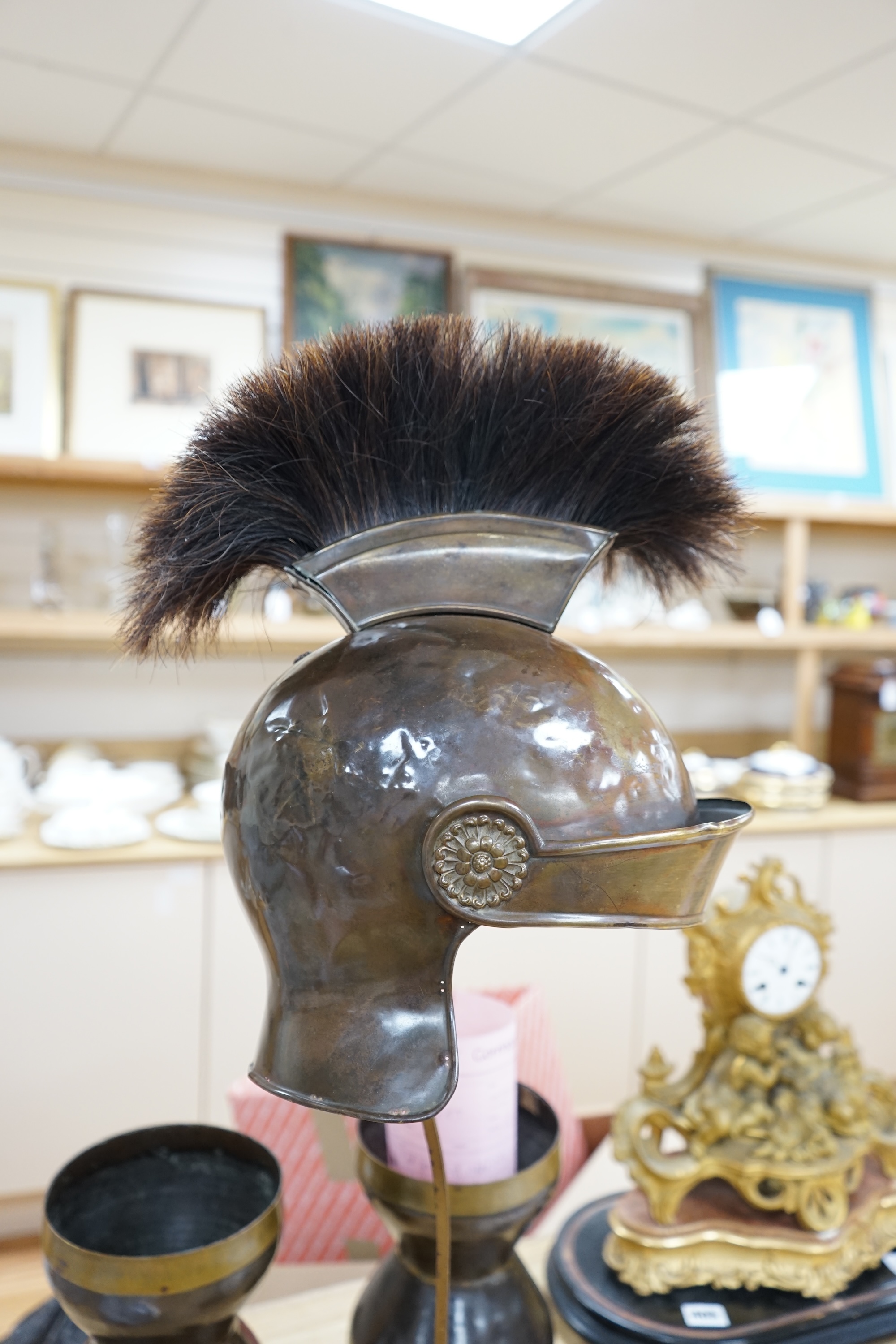 A group of metalware including a Roman style theatrical helmet on stand, a pair of vases and an oil lamp filler, largest 75cm high. Condition - fair to good, lamp filler in antique condition